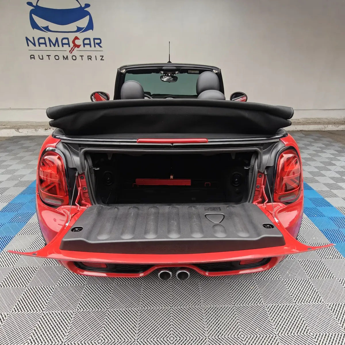 Mini Cooper S Convertible Hot Chili 2021 seminuevo color rojo con la cajuela abierta, vista trasera directa en el showroom de Namacar Automotriz.