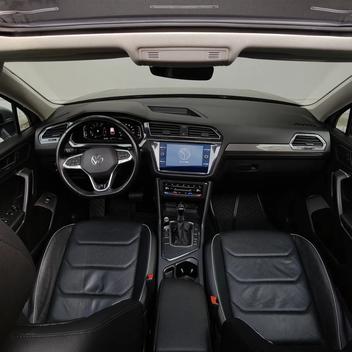 Vista interior frontal del tablero completo de una SUV Volkswagen Tiguan 1.4 R-Line 2022 seminueva, tomada desde una posición central trasera elevada entre ambos asientos bajo la apertura del quemacocos panorámico.