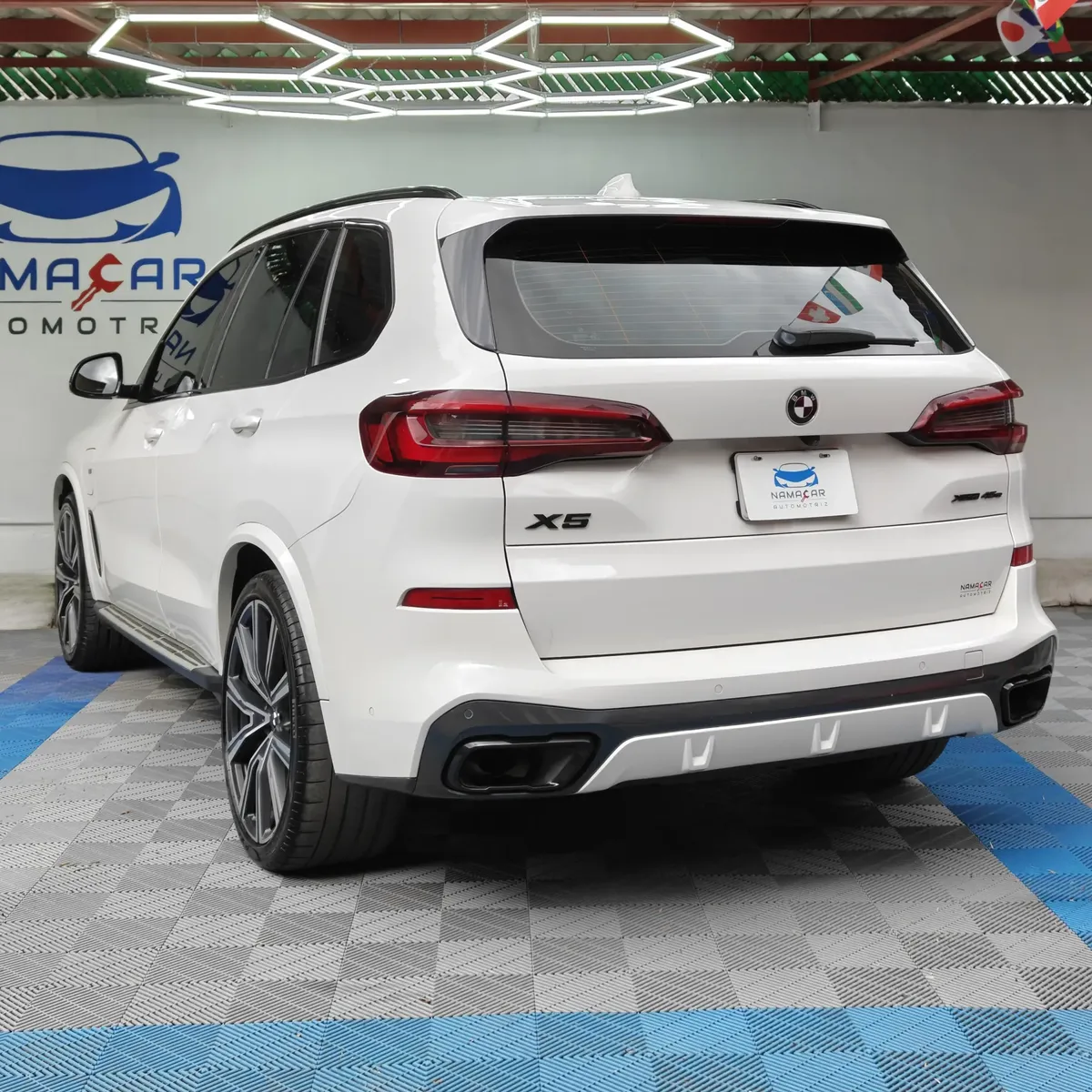 SUV de lujo BMW X5 2021 seminueva en color blanco, vista exterior trasera en ángulo de tres cuartos izquierda en las instalaciones de Namacar Automotriz.