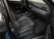 Vista interior desde la puerta del copiloto abierta que muestra el asiento deportivo delantero derecho con ajustes eléctricos forrado en piel negra con costuras rojas, el estribo de aluminio iluminado S Line, el tablero con emblema quattro y la consola central de una camioneta SUV Audi Q3 2.0 S Line 180 Hp transmisión DSG automática año 2022 seminueva en ángulo oblicuo derecho.