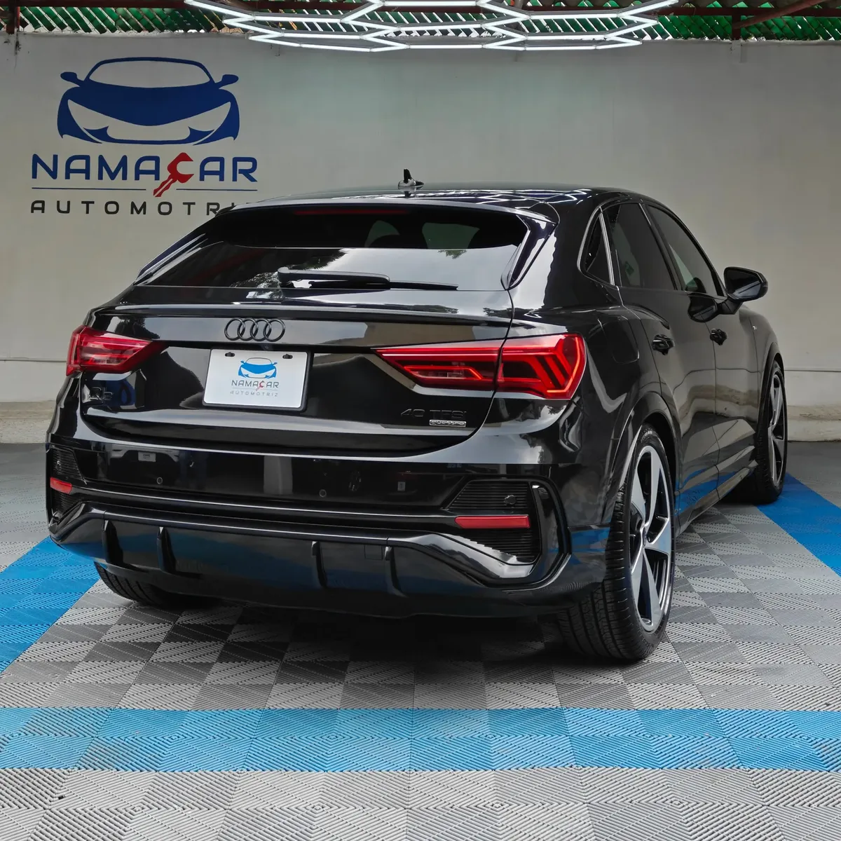 Camioneta SUV coupé de lujo Audi Q3 Sportback 2.0 S Line 180 Hp transmisión DSG automática año 2022 seminueva en color negro, vista exterior trasera en ángulo de tres cuartos derecha exhibida en Namacar Automotriz.